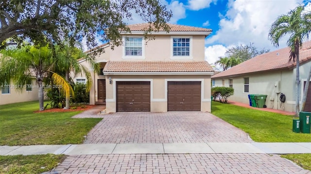 mediterranean / spanish house featuring a garage and a front lawn