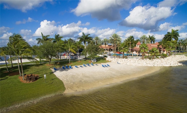 view of community with a water view and a yard