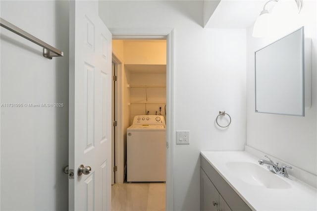 bathroom with vanity and washer / clothes dryer