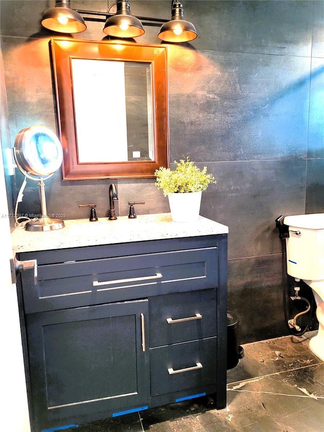 bathroom featuring toilet and vanity