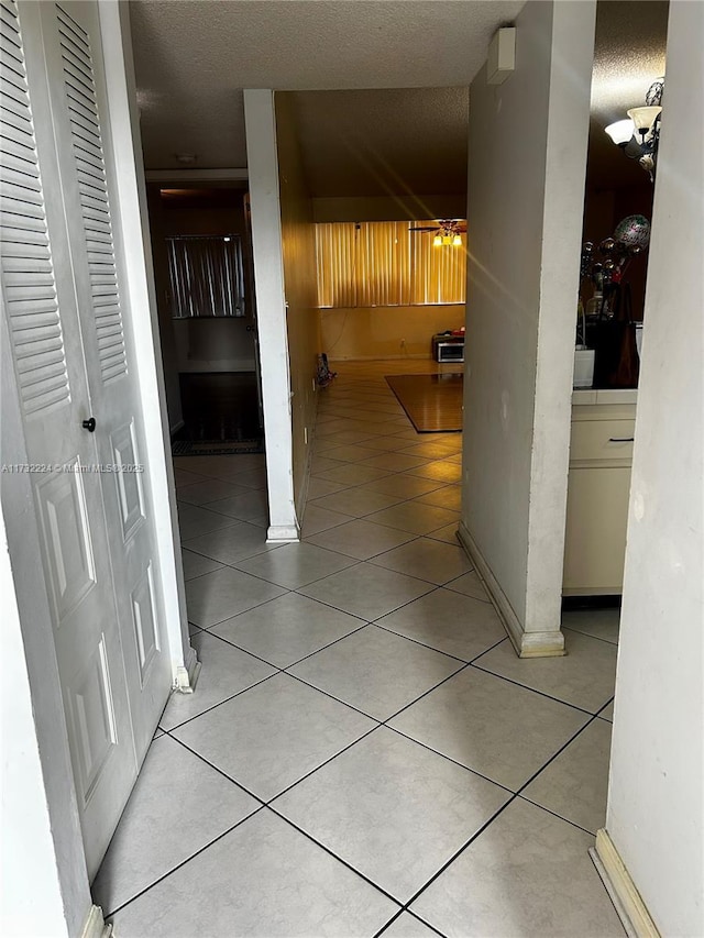 hall with light tile patterned floors