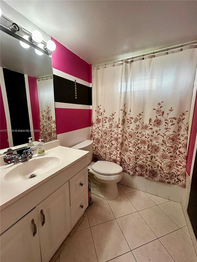 bathroom featuring vanity, tile patterned floors, and toilet