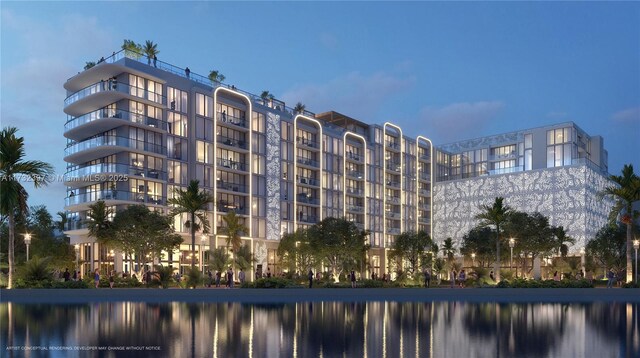 outdoor building at dusk featuring a water view