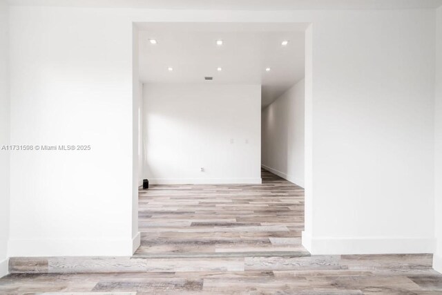 empty room with light hardwood / wood-style flooring