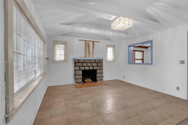 living room featuring a fireplace, a textured ceiling, and vaulted ceiling with beams