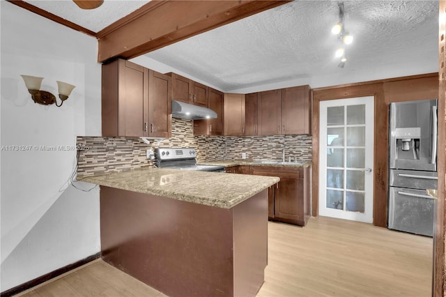 kitchen with decorative backsplash, light stone countertops, kitchen peninsula, and appliances with stainless steel finishes