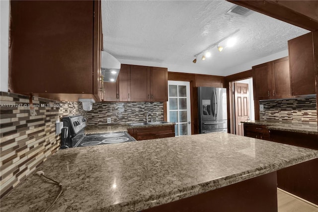 kitchen featuring appliances with stainless steel finishes, tasteful backsplash, sink, dark brown cabinetry, and a textured ceiling