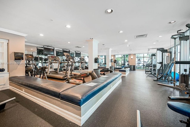 exercise room featuring crown molding and decorative columns