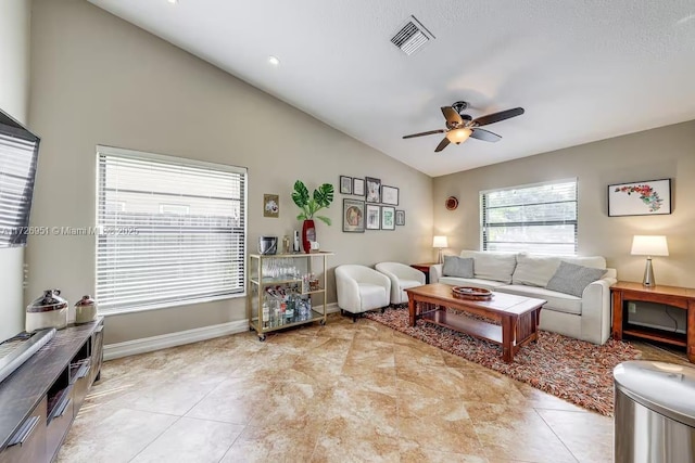 living room featuring vaulted ceiling, light tile patterned floors, and ceiling fan