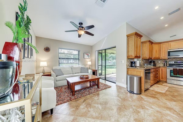 living room featuring lofted ceiling, sink, and ceiling fan