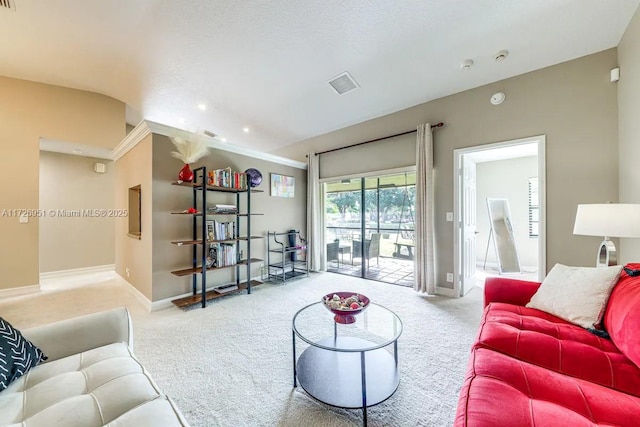 living room featuring lofted ceiling and light colored carpet