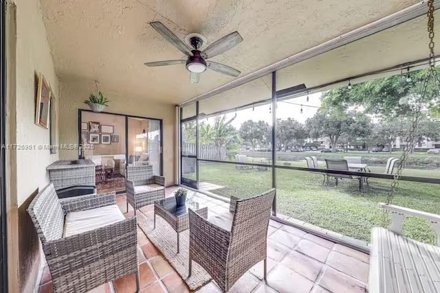 sunroom / solarium featuring ceiling fan