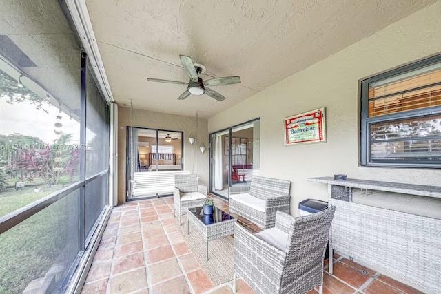 sunroom with ceiling fan