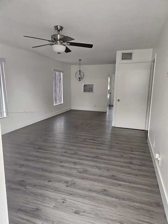 empty room featuring ceiling fan and dark hardwood / wood-style flooring