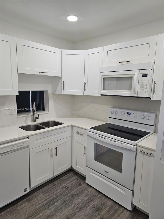 kitchen with sink, white appliances, and white cabinets