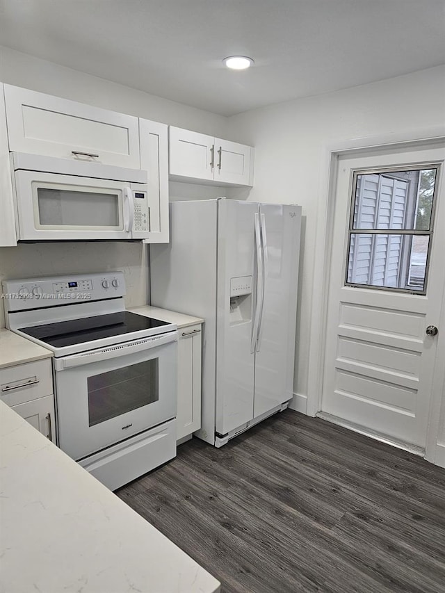 kitchen with white cabinetry, white appliances, dark hardwood / wood-style flooring, and light stone countertops