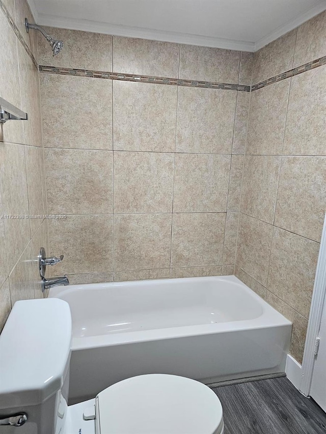 bathroom with shower / bathtub combination, ornamental molding, toilet, and hardwood / wood-style floors