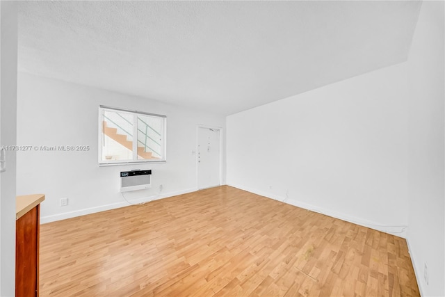 unfurnished living room featuring heating unit and light hardwood / wood-style flooring