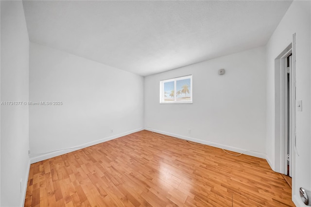 unfurnished room featuring light hardwood / wood-style floors