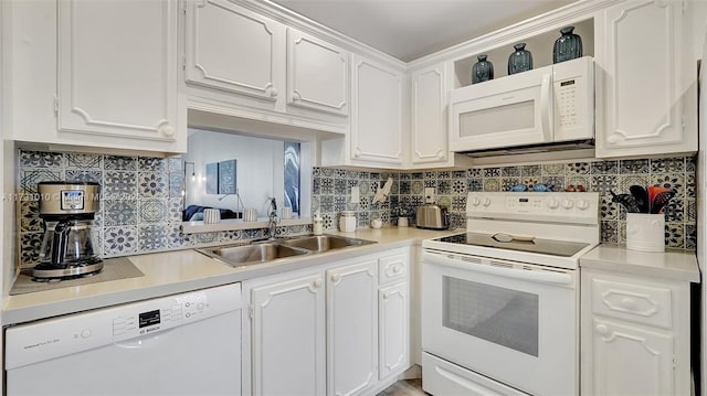 kitchen with sink, white cabinets, and white appliances