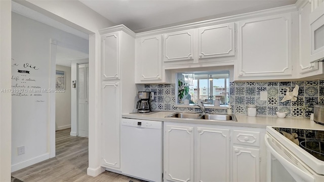 kitchen with sink, light wood-type flooring, backsplash, white cabinets, and white appliances