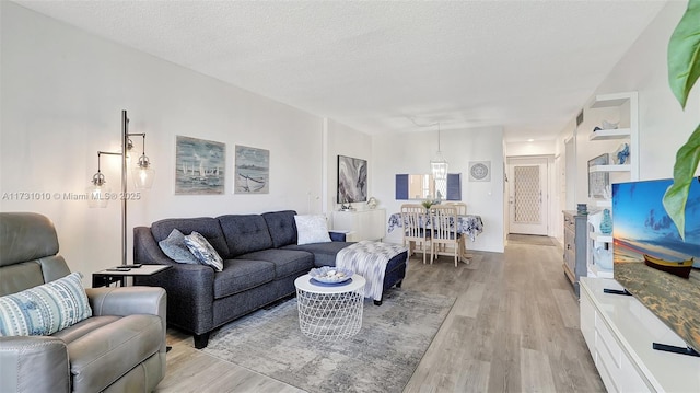 living room featuring a textured ceiling and light hardwood / wood-style flooring