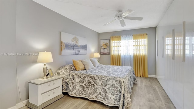 bedroom with light hardwood / wood-style flooring and ceiling fan