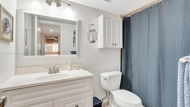 bathroom featuring vanity, toilet, and a shower with shower curtain