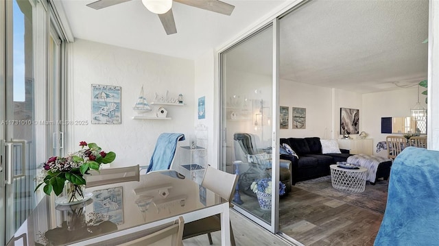 interior space featuring hardwood / wood-style flooring, ceiling fan, and a textured ceiling