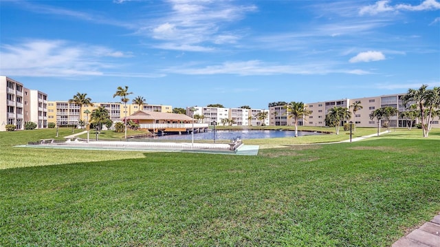 surrounding community featuring a water view and a lawn