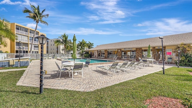 view of pool featuring a yard and a patio area