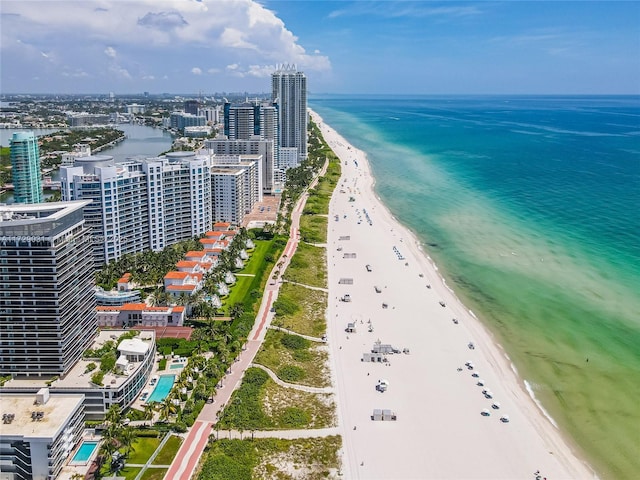 birds eye view of property with a water view and a view of the beach