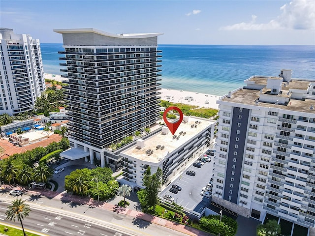 birds eye view of property featuring a water view and a view of the beach