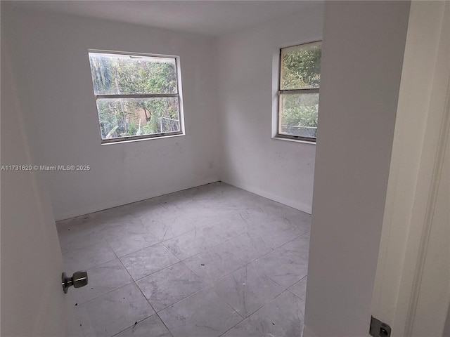 unfurnished room with light tile patterned floors