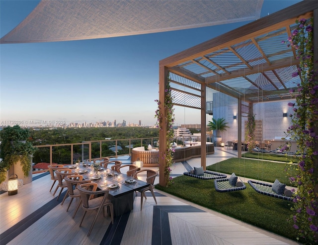 deck at dusk with a pergola and a lawn