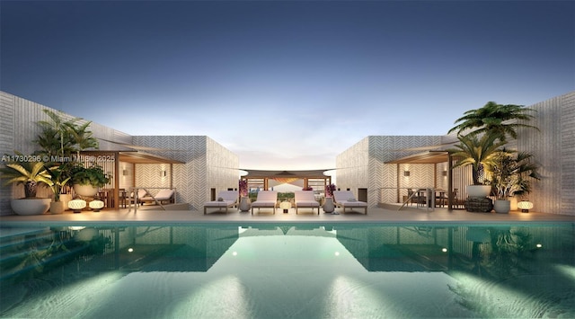 pool at dusk with a patio area