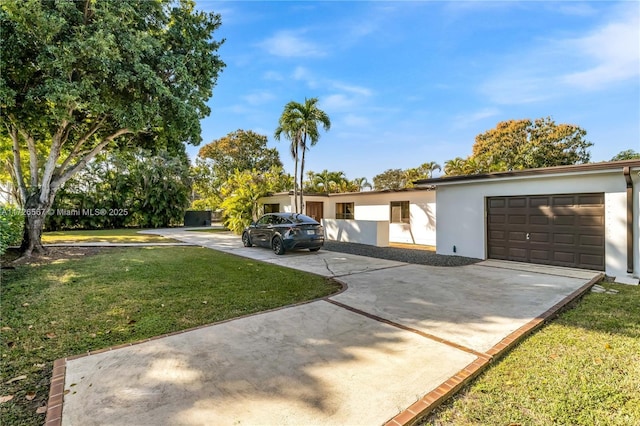 view of front of property featuring a garage and a front lawn