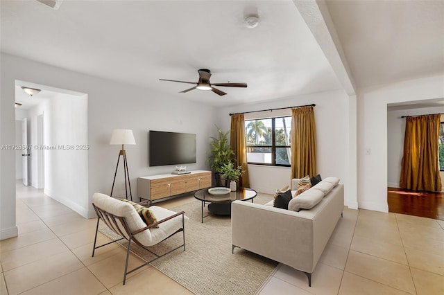 living room with light tile patterned floors and ceiling fan