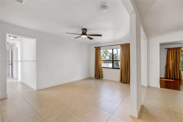 unfurnished room featuring light tile patterned floors and ceiling fan