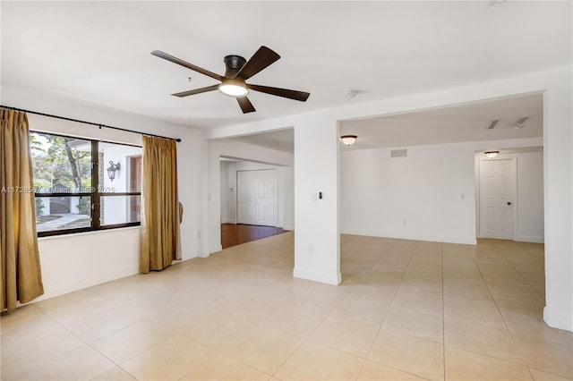 tiled empty room with ceiling fan