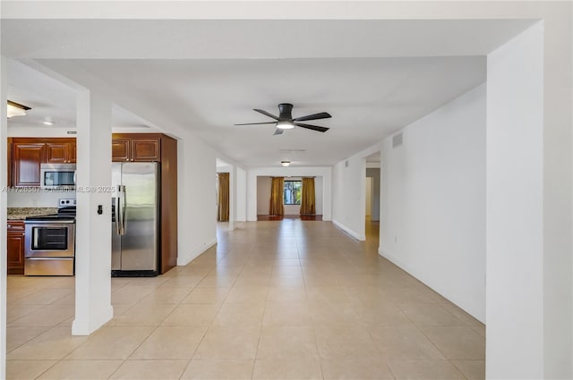 kitchen with stainless steel appliances, light tile patterned floors, and ceiling fan