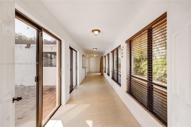 corridor featuring light tile patterned floors