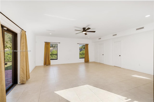 bedroom featuring multiple closets, ceiling fan, access to exterior, and light tile patterned floors