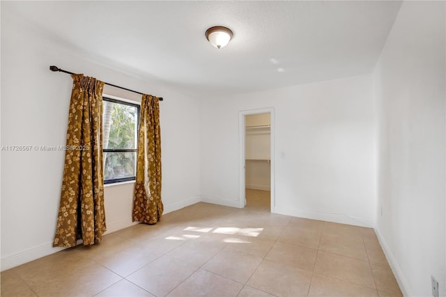 tiled empty room featuring ceiling fan, french doors, and a healthy amount of sunlight