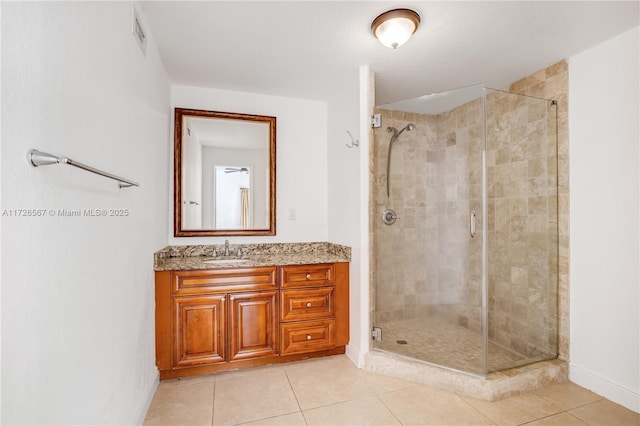 bathroom featuring vanity, tile patterned floors, and walk in shower