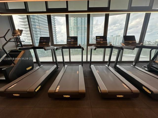 gym with a wall of windows