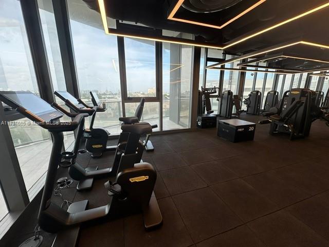 gym featuring floor to ceiling windows and a wealth of natural light