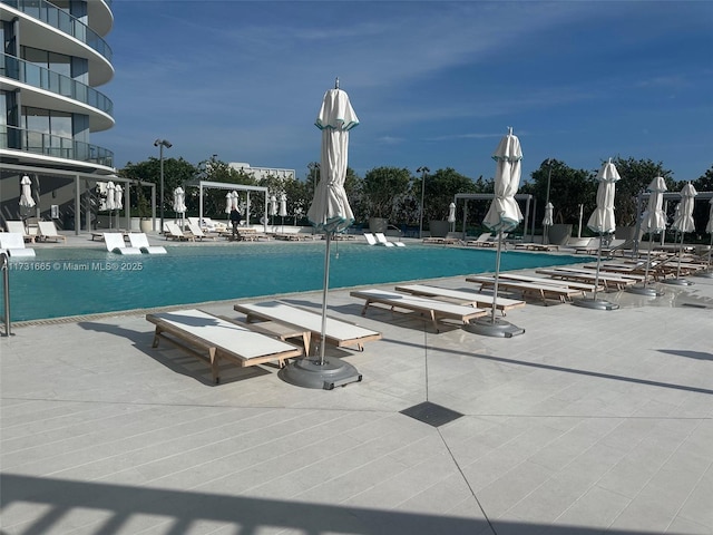 view of swimming pool with a patio