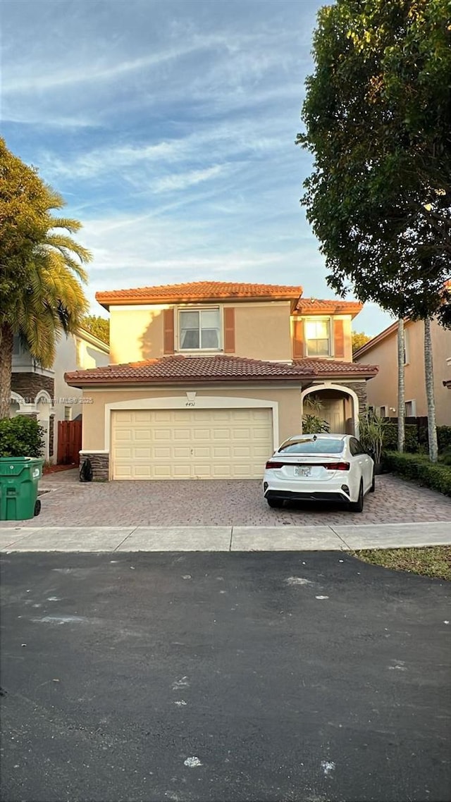 mediterranean / spanish-style home with a garage