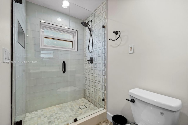 bathroom with toilet and an enclosed shower